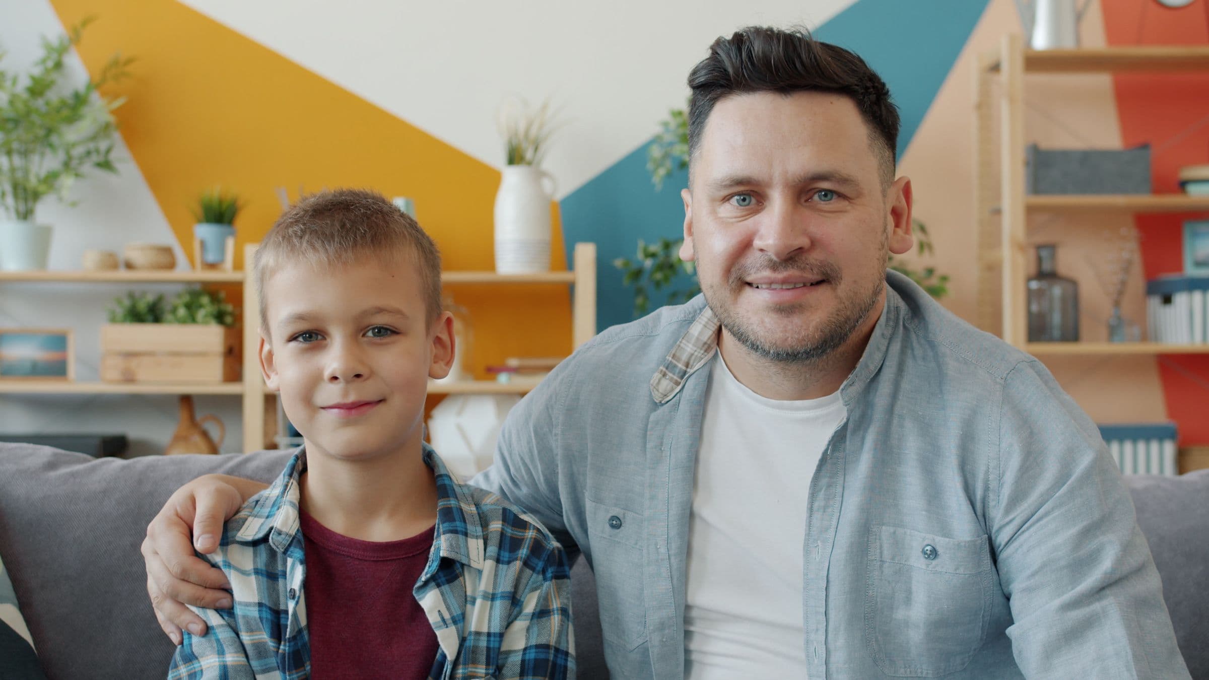 A father and son sitting together at home