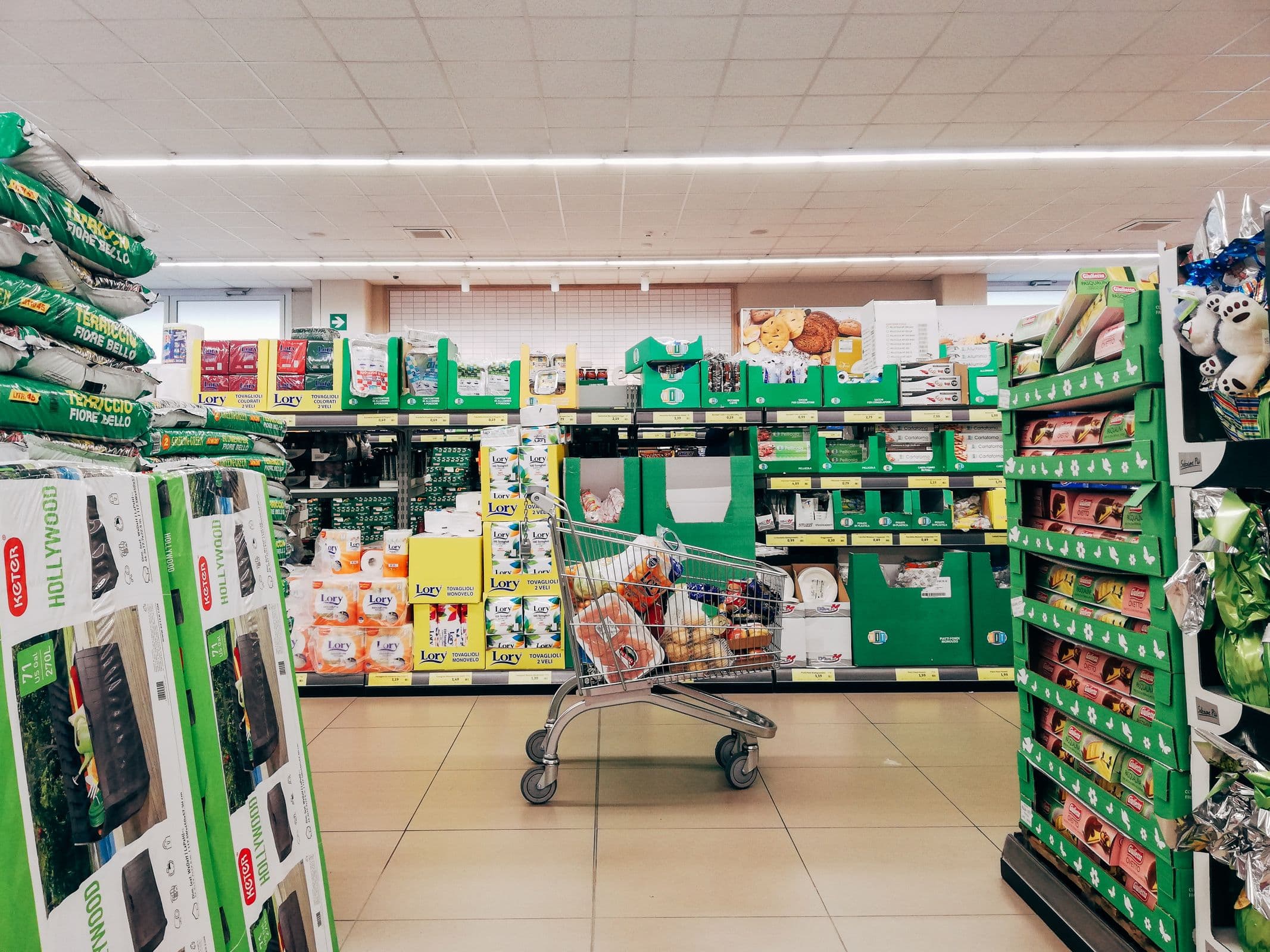A shopping cart in a supermarket aisle