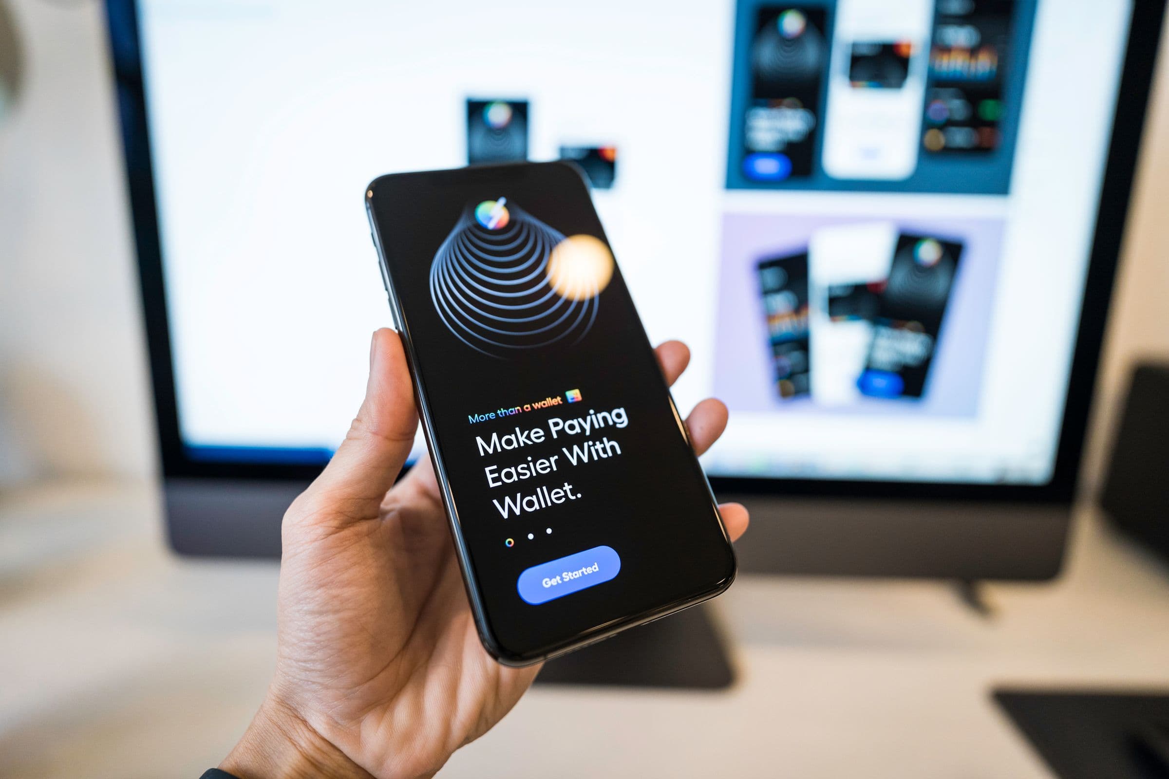 A hand holding a smartphone displaying a digital banking app